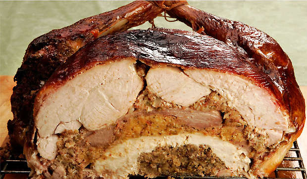 The layered meal is stuffed with dressing in between each type of poultry.