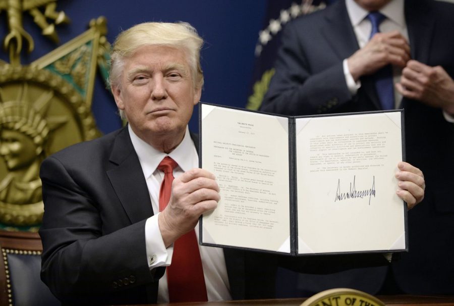 US President Donald Trump signs Executive Orders in the Hall of Heroes at the Department of Defense Friday, Jan. 27, 2017 in Arlington, Va.  
