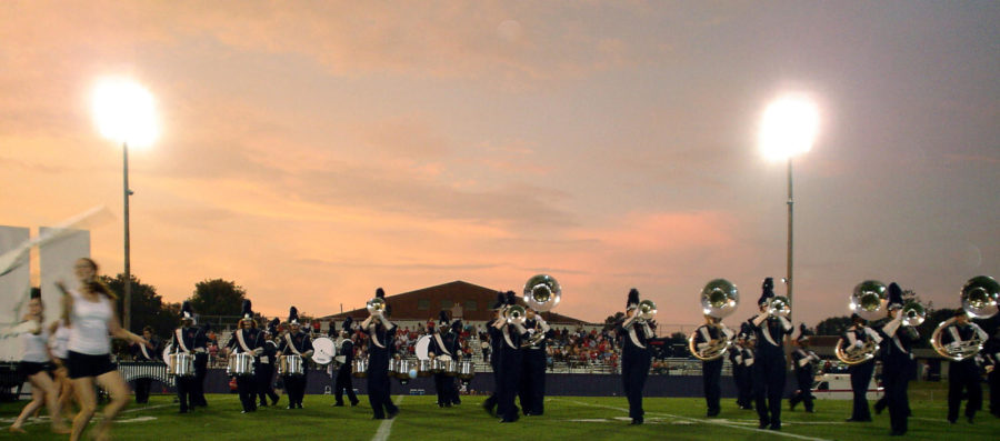 A marching band performing at halftime of a football game.