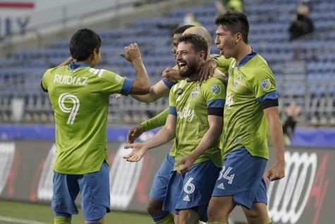 Seattle Sounders players celebrate after scoring a goal.