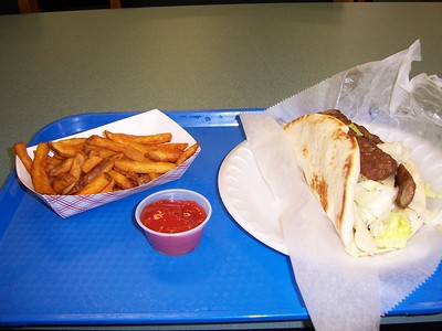 Taco and fries on a blue tray.