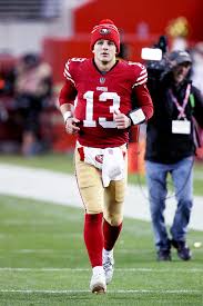 Football player running on the field before a game.