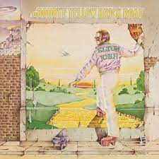 The Album cover to Etlon Johns Goodbye Yellow Brick Road. It has a very glamorous sytle walking onto a yellow brick road.