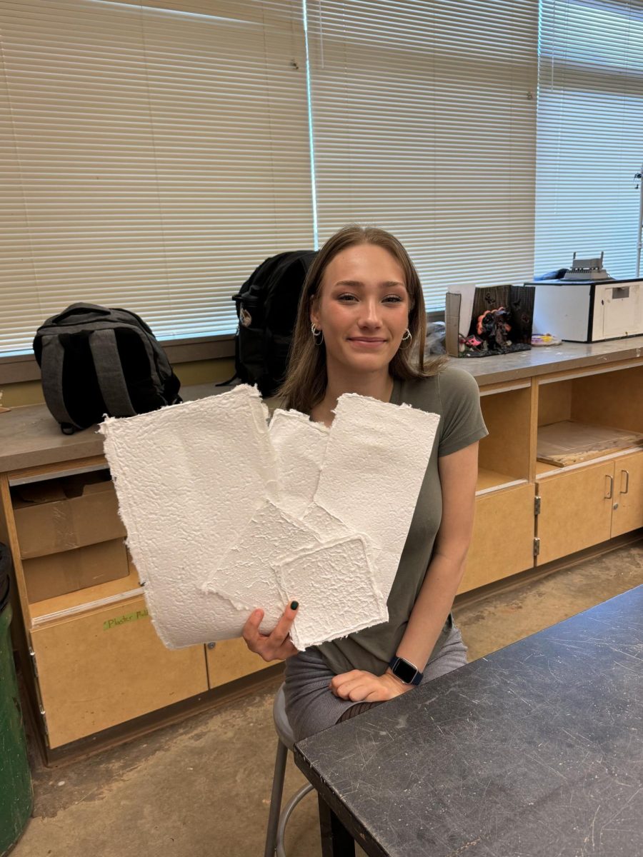 Charlotte Walk- CHS Advanced Ceramics Student, with her paper that she made herself 