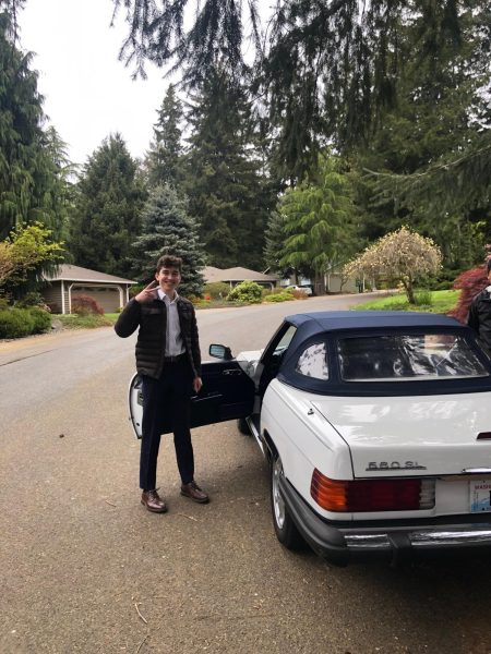 Preston standing next to a white Mercedes Benz 550 SL from the 80's